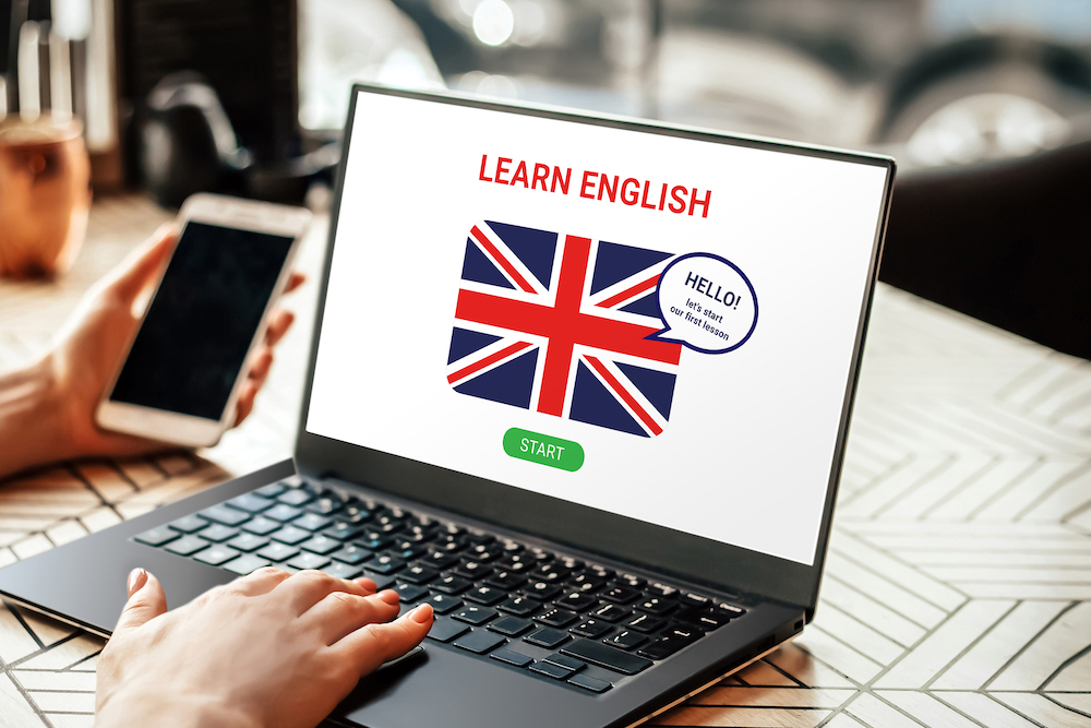 woman learning English online with laptop screen. Student using laptop doing online course on english